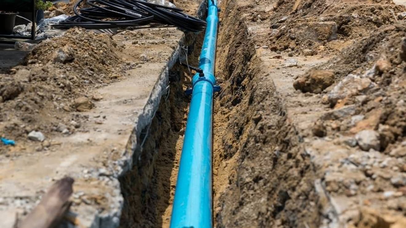 new water main pipe in a dug out trench