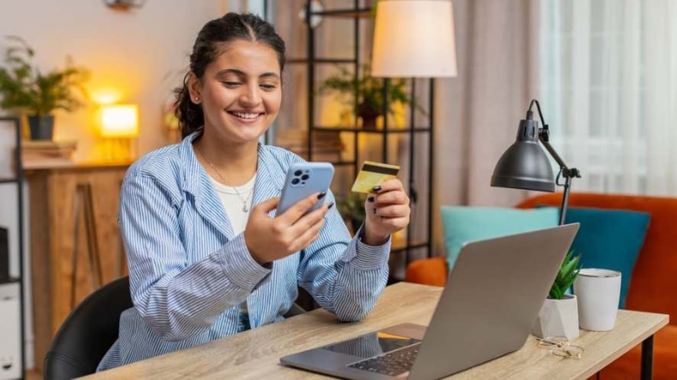 Woman sat on the sofa using MyAccount on a mobile phone