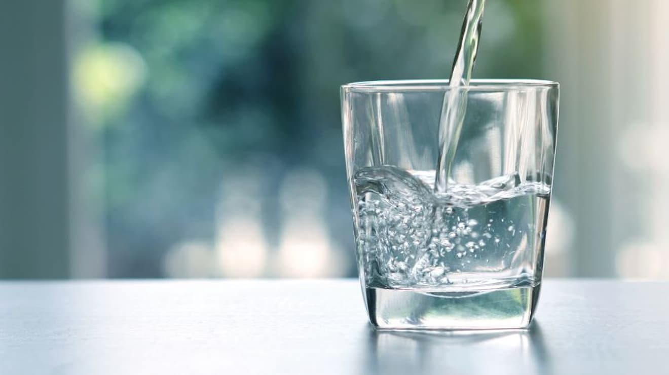Water being poured into a small glass